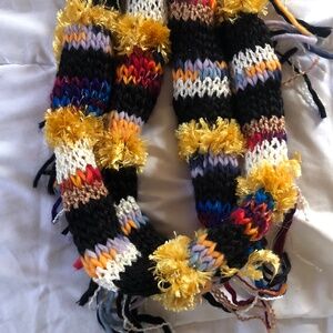 Black, white, yellow/orange and blue crochet yarn scarf